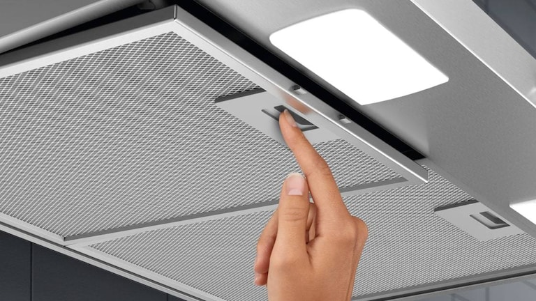 Hand removing cooker hood filter